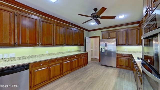 kitchen featuring light stone counters, ornamental molding, stainless steel appliances, and light hardwood / wood-style floors