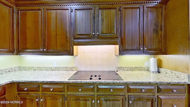 kitchen featuring black electric cooktop and tasteful backsplash