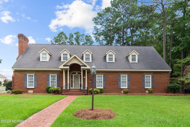 cape cod home with a front yard