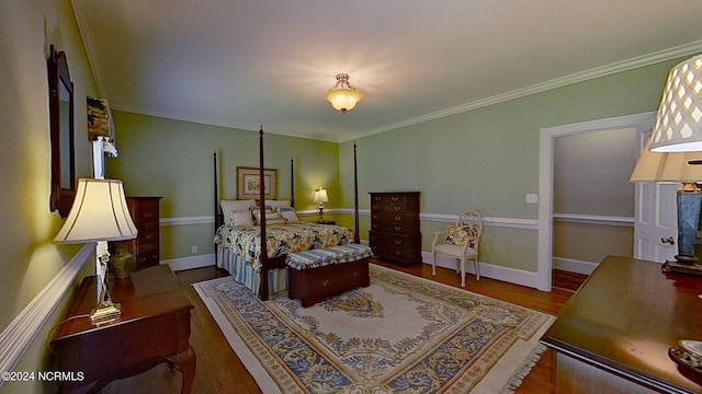 bedroom with hardwood / wood-style floors and ornamental molding