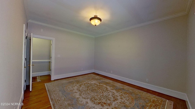 unfurnished room featuring crown molding and light hardwood / wood-style flooring