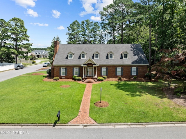 cape cod house featuring a front lawn