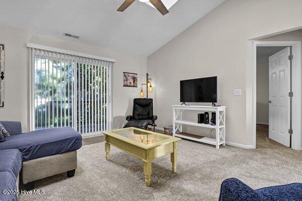 living room with high vaulted ceiling, ceiling fan, and carpet flooring