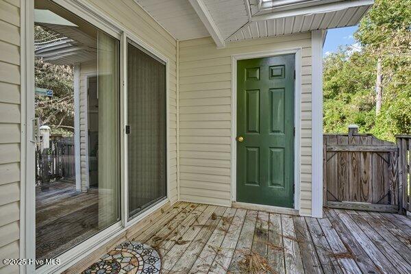 view of exterior entry featuring a deck