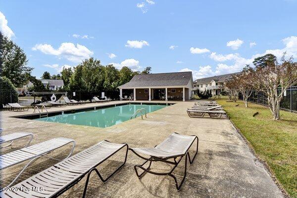 view of swimming pool with a patio and a lawn