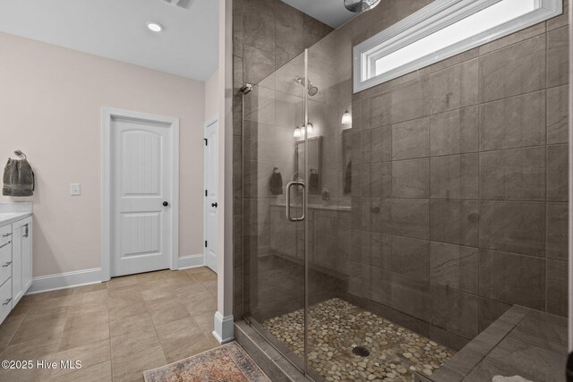 bathroom with vanity, tile patterned floors, and a shower with door