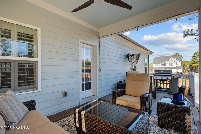 wooden deck with a grill, an outdoor hangout area, and ceiling fan