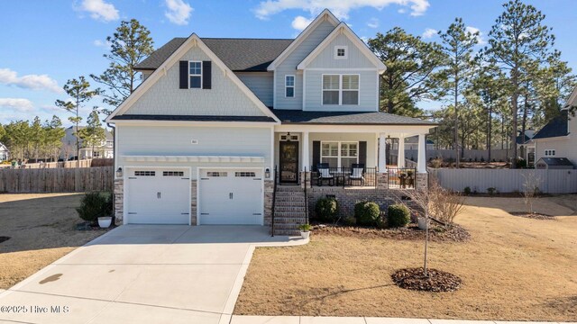 craftsman-style home with a garage and covered porch