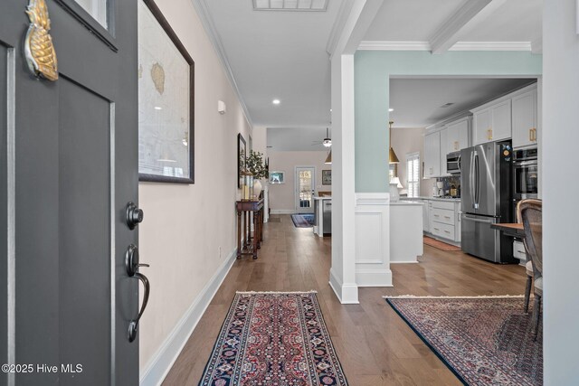 foyer with crown molding, ceiling fan, and hardwood / wood-style flooring