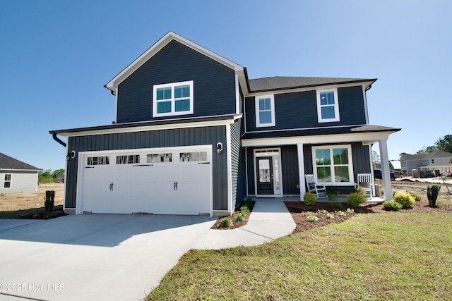 view of front of home featuring a garage, a porch, and a front yard