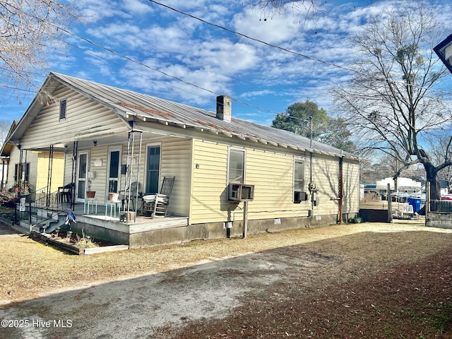 view of front facade with cooling unit and a porch