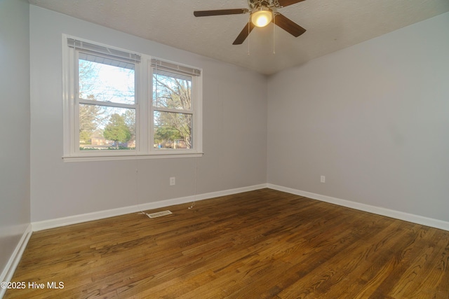 empty room with hardwood / wood-style flooring, ceiling fan, and a textured ceiling