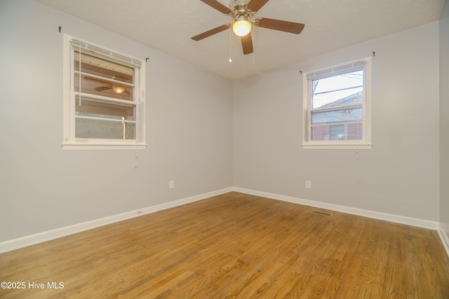 empty room featuring ceiling fan and light wood-type flooring