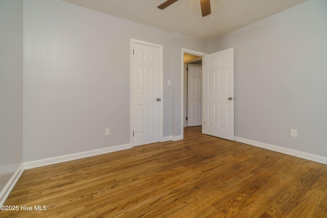 unfurnished room with hardwood / wood-style flooring, a textured ceiling, and ceiling fan