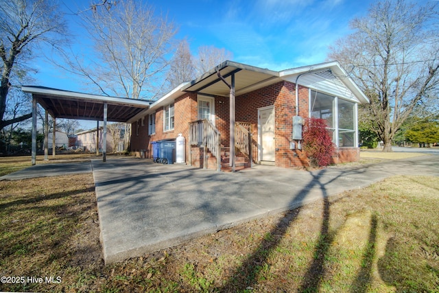 view of front facade featuring a carport and a sunroom