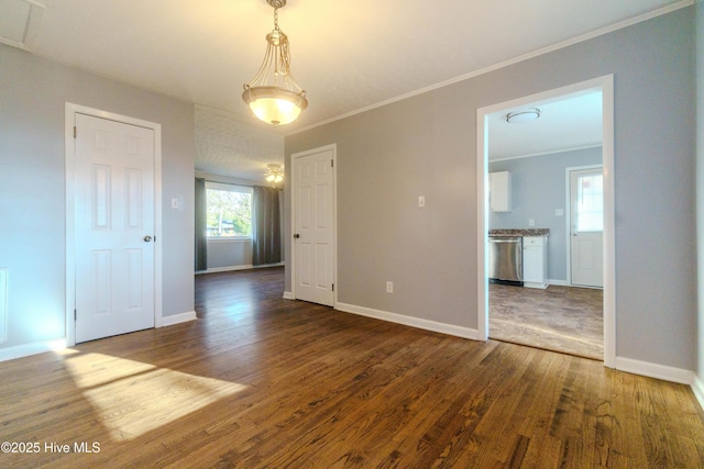 unfurnished room featuring hardwood / wood-style floors and crown molding