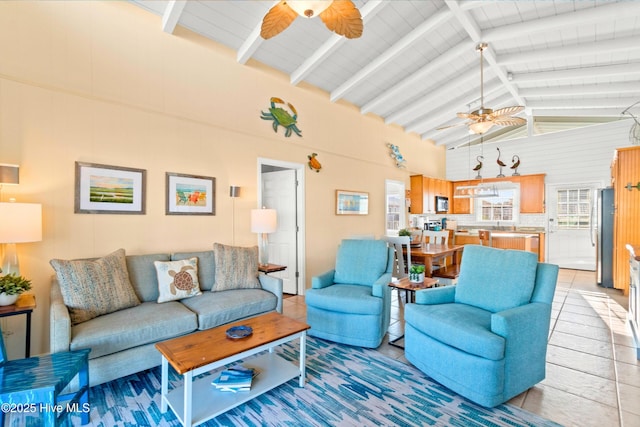 living room with ceiling fan, high vaulted ceiling, and beamed ceiling