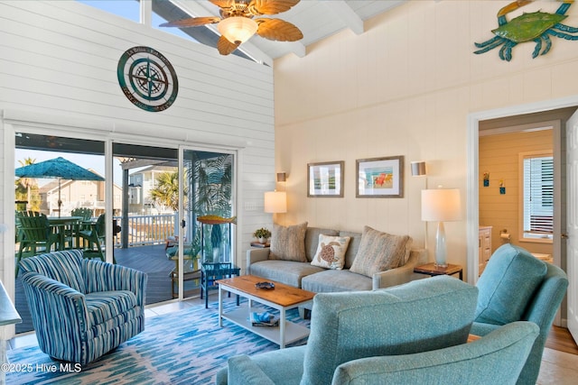 living room featuring high vaulted ceiling, beam ceiling, and a ceiling fan