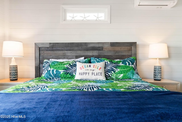 bedroom featuring an AC wall unit