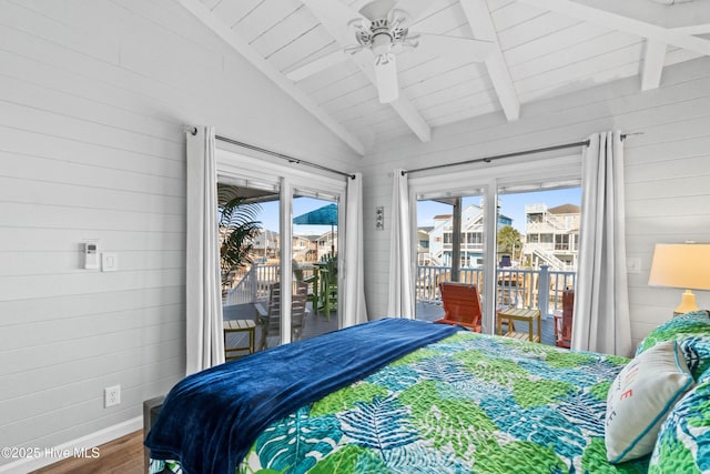 bedroom featuring lofted ceiling with beams, a ceiling fan, wood walls, wood finished floors, and access to outside