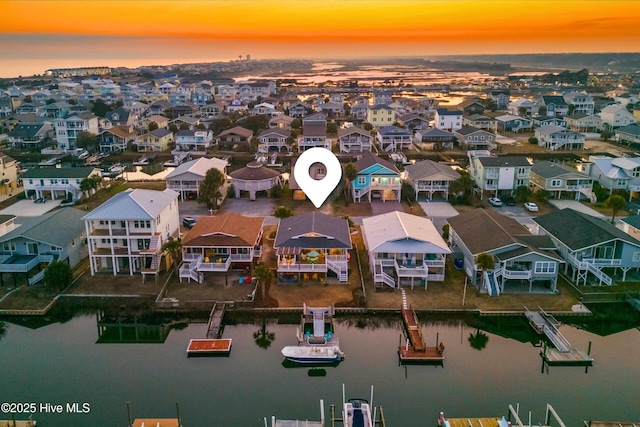 bird's eye view featuring a water view and a residential view