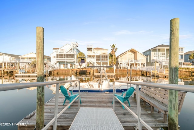 dock area featuring a water view and a residential view