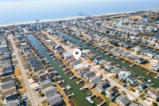 birds eye view of property with a water view and a residential view