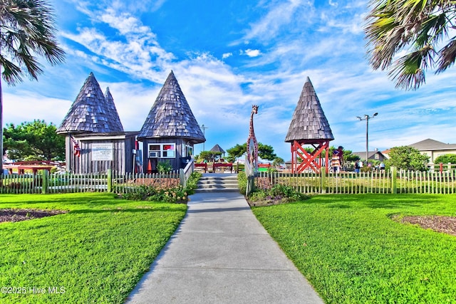 view of play area featuring fence and a lawn