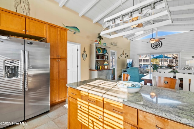 kitchen featuring beam ceiling, light tile patterned flooring, ceiling fan, and stainless steel fridge with ice dispenser