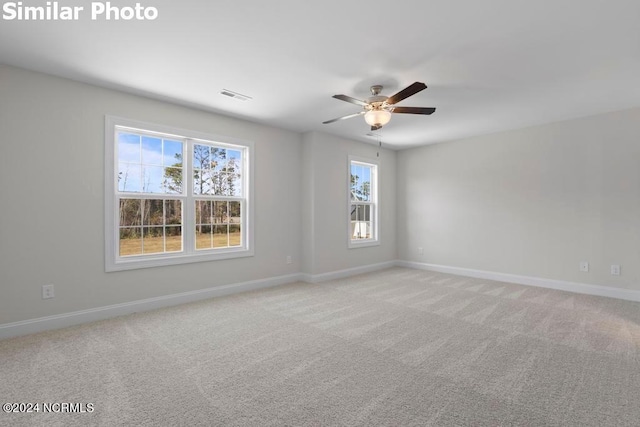 empty room with light colored carpet and ceiling fan