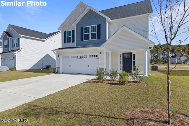 view of front of house with central AC, a garage, and a front yard