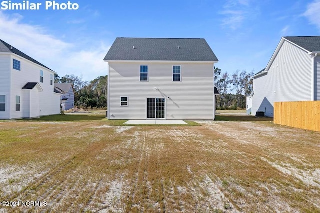 rear view of house featuring a yard and a patio area