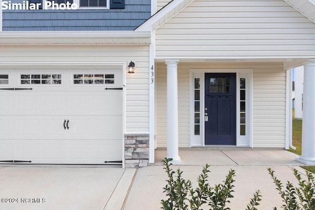 view of exterior entry featuring a garage