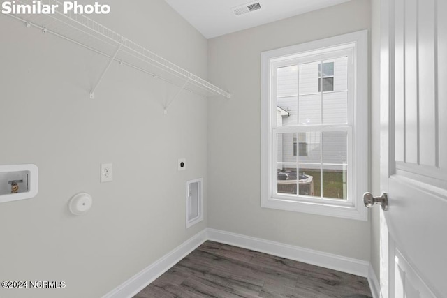 laundry room featuring hookup for an electric dryer, dark wood-type flooring, and washer hookup