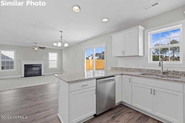 kitchen featuring sink, dishwasher, hanging light fixtures, white cabinets, and kitchen peninsula