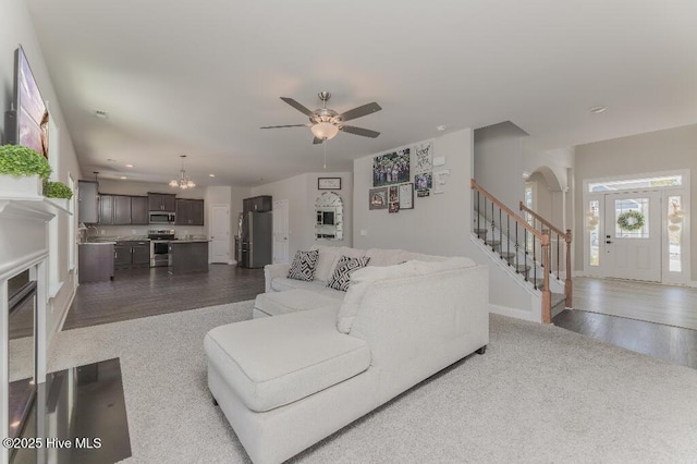 living room with dark hardwood / wood-style floors and ceiling fan