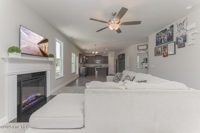 living room featuring dark hardwood / wood-style floors and ceiling fan