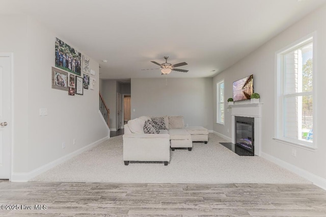 living room with ceiling fan and light hardwood / wood-style flooring