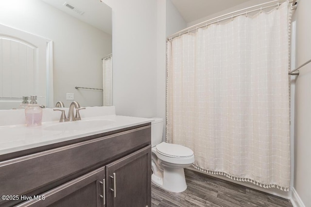 bathroom featuring wood-type flooring, vanity, and toilet