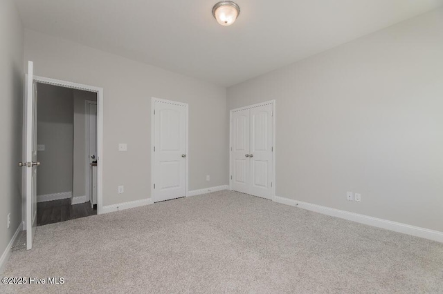 unfurnished bedroom featuring carpet floors and a closet