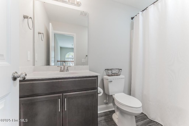 bathroom with vanity, hardwood / wood-style floors, and toilet