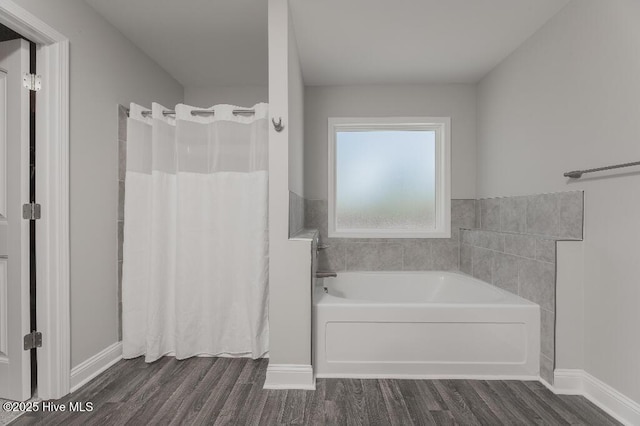 bathroom with hardwood / wood-style flooring and plus walk in shower