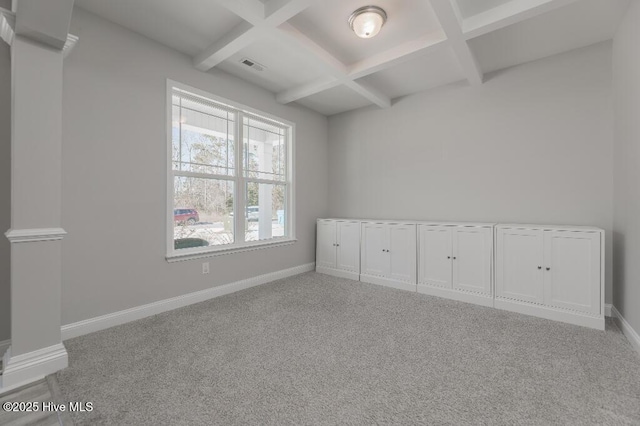 carpeted spare room featuring beamed ceiling and coffered ceiling