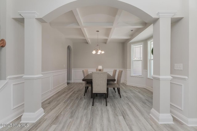 dining room with coffered ceiling, beam ceiling, light hardwood / wood-style floors, and ornate columns