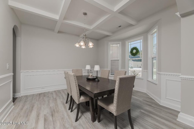 dining room featuring coffered ceiling, hardwood / wood-style floors, and a notable chandelier