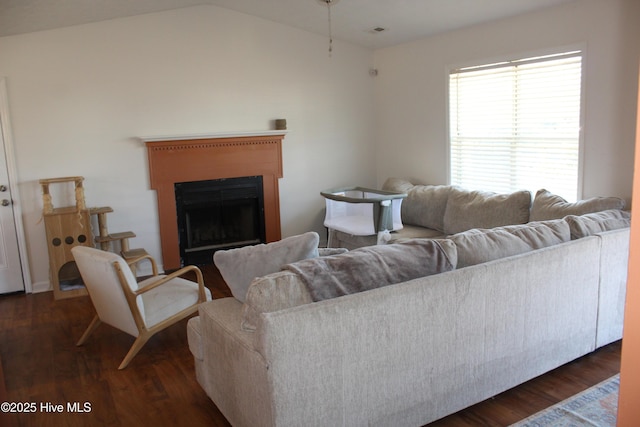 living room with dark hardwood / wood-style flooring and vaulted ceiling