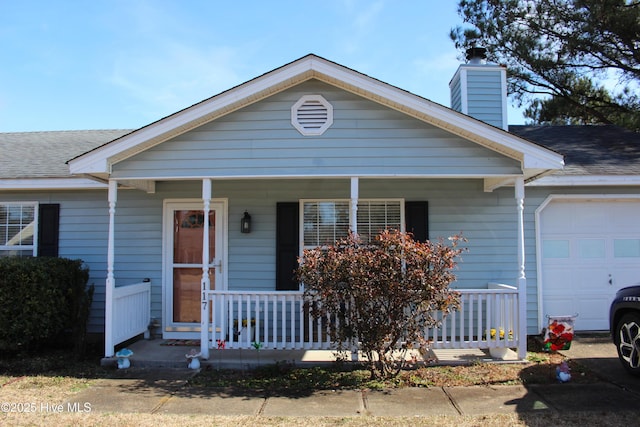 view of front of house featuring a garage and a porch