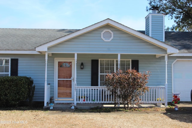 view of front of property with a garage and covered porch