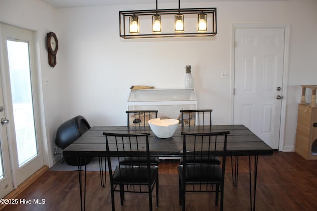 dining space with dark wood-type flooring