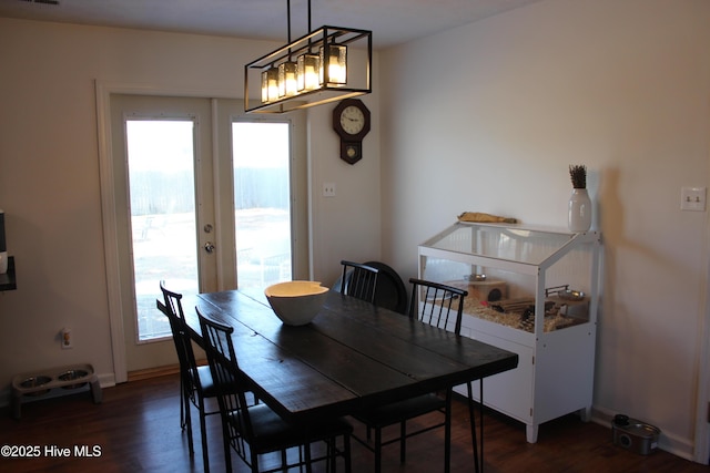 dining space with french doors, a healthy amount of sunlight, and dark hardwood / wood-style floors